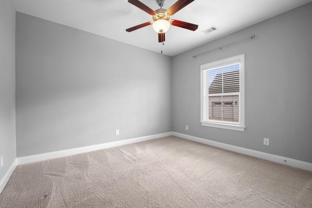 carpeted spare room featuring ceiling fan