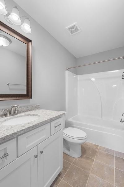 full bathroom with vanity, tile patterned flooring, toilet, and shower / bath combination