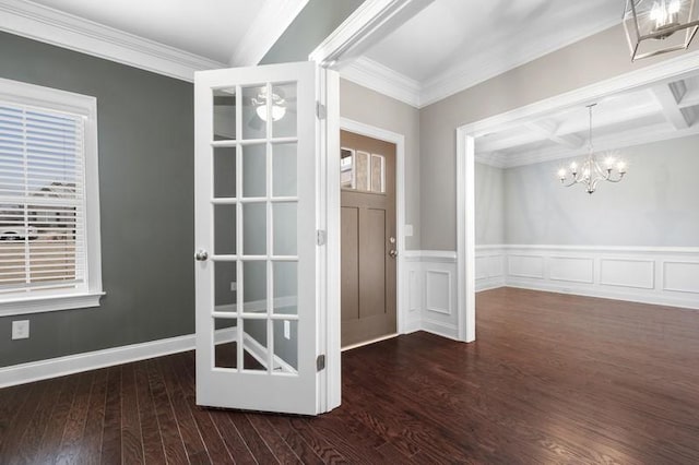 foyer entrance featuring dark hardwood / wood-style flooring, crown molding, coffered ceiling, and a chandelier