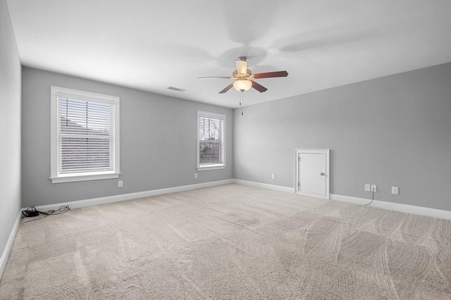 empty room with light colored carpet and ceiling fan