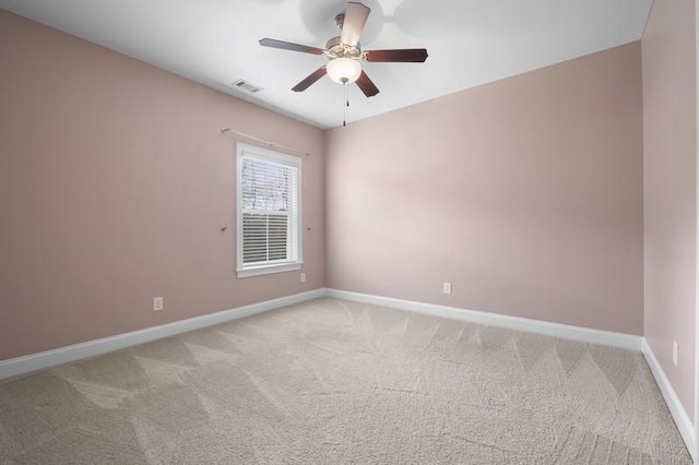 carpeted spare room with ceiling fan