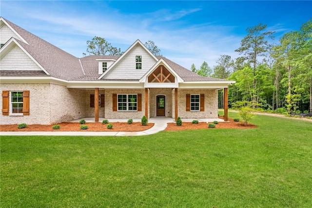 view of front of home with covered porch and a front yard