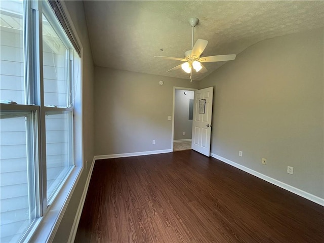 1385 S Donahue Dr Unit 4201, Auburn, AL 36832 - empty room with vaulted ceiling, dark wood-type flooring, a ceiling fan, baseboards, and a textured ceiling