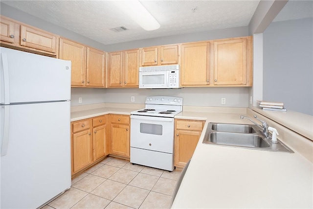 1385 S Donahue Dr Unit 4201, Auburn, AL 36832 - kitchen featuring white appliances, light brown cabinets, light tile patterned floors, light countertops, and a textured ceiling