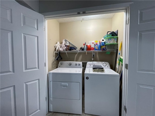 1385 S Donahue Dr Unit 4201, Auburn, AL 36832 - laundry room featuring washing machine and dryer, a textured ceiling, and light tile patterned flooring