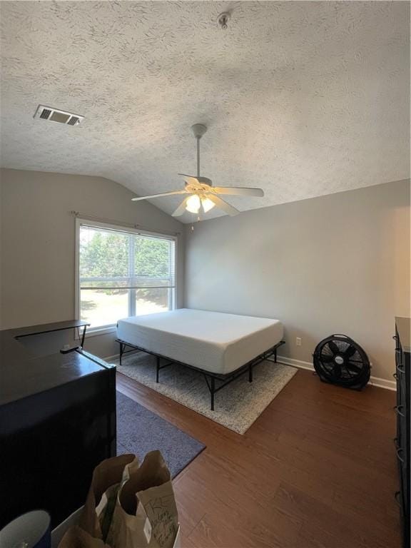 1385 S Donahue Dr Unit 4201, Auburn, AL 36832 - bedroom with vaulted ceiling, wood finished floors, a textured ceiling, baseboards, and ceiling fan