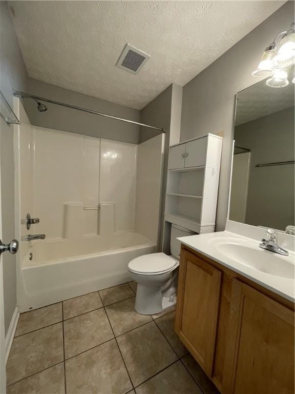 1385 S Donahue Dr Unit 4201, Auburn, AL 36832 - bathroom featuring tile patterned flooring, toilet, bathing tub / shower combination, vanity, and a textured ceiling