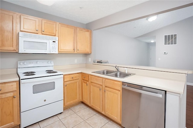 1385 S Donahue Dr Unit 4201, Auburn, AL 36832 - kitchen featuring white appliances, a peninsula, light brown cabinetry, light tile patterned floors, and light countertops