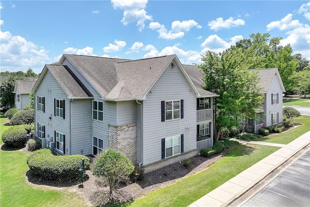 1385 S Donahue Dr Unit 4201, Auburn, AL 36832 - view of side of property with roof with shingles and a lawn
