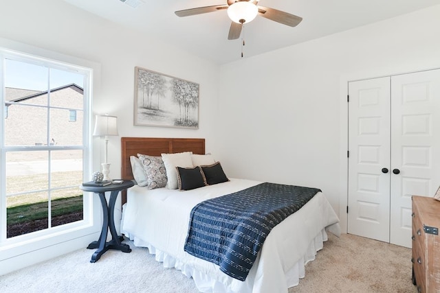 carpeted bedroom with a closet and a ceiling fan