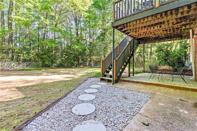 view of yard featuring stairway, a patio area, fence, and a deck