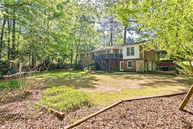 view of yard featuring a fenced backyard and stairway
