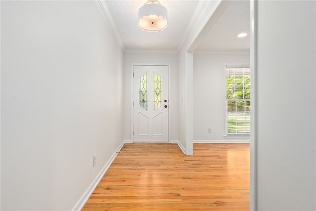 entryway with light wood finished floors, baseboards, and ornamental molding