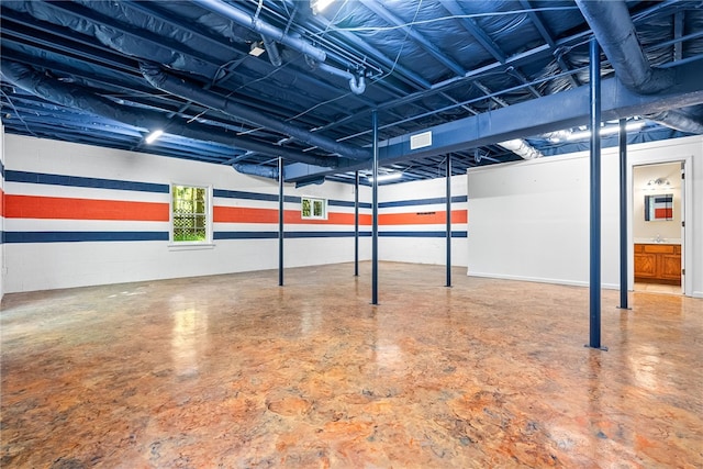 basement featuring visible vents and a sink