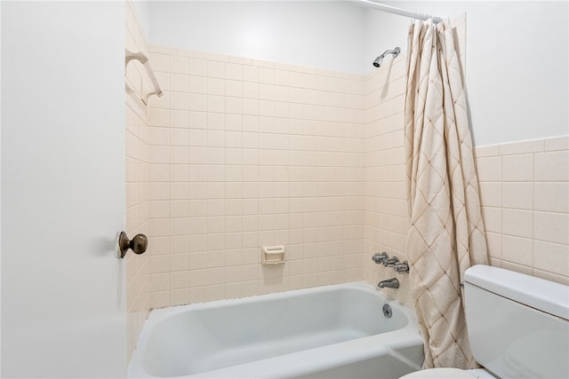 full bathroom with shower / tub combo with curtain, toilet, and tile walls