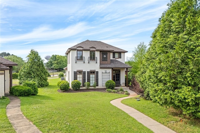 2674 Canal Ct, Auburn, AL 36830 - view of front of property with a balcony, stucco siding, a shingled roof, and a front lawn