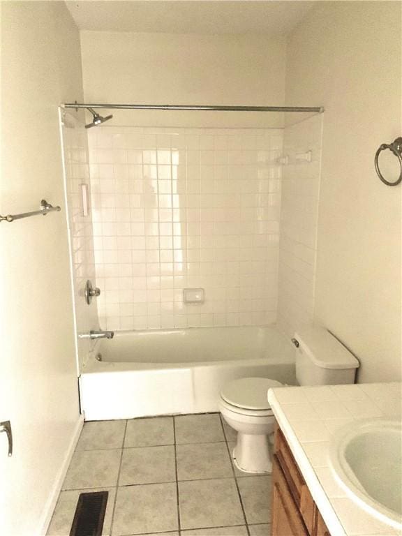 full bathroom with toilet, tile patterned flooring, vanity, and tiled shower / bath