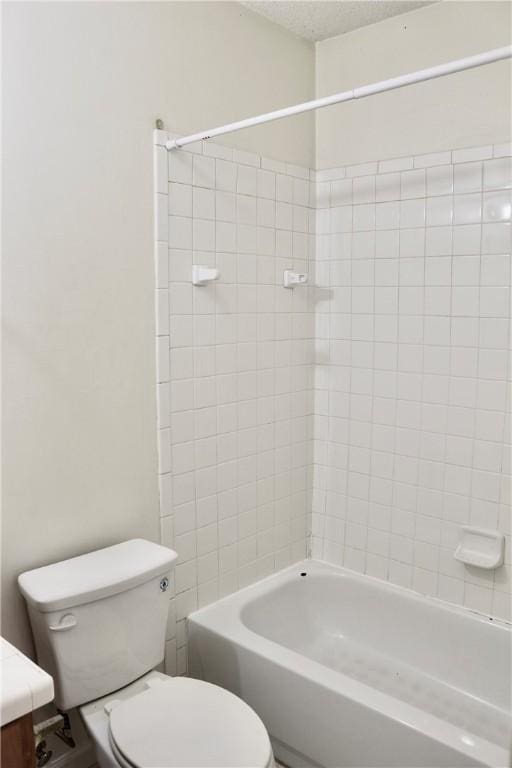 full bath with a textured ceiling,  shower combination, vanity, and toilet