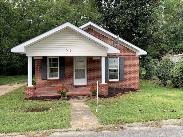 bungalow featuring a front lawn and a porch