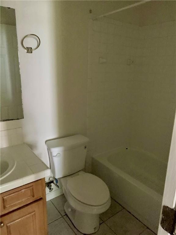 bathroom with toilet, vanity, and tile patterned floors