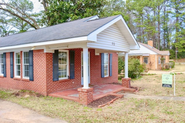 view of front facade featuring a porch and brick siding