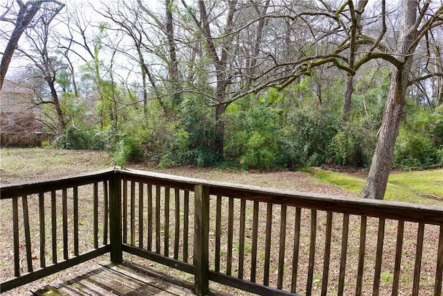 wooden deck featuring a forest view