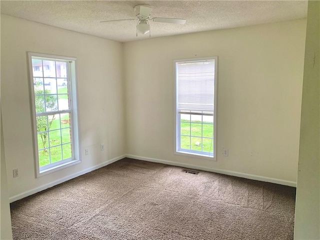 carpeted empty room featuring a textured ceiling and ceiling fan