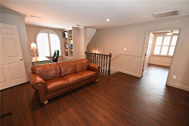 living room with ceiling fan, dark wood-type flooring, and ornamental molding