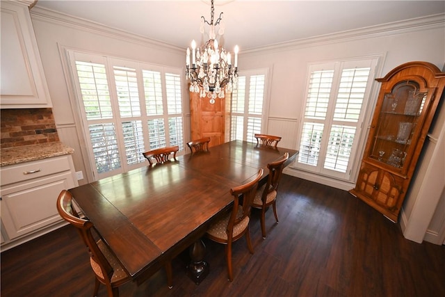 dining space with crown molding, dark wood-type flooring, and a chandelier