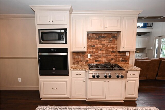 1900 Wrights Mill Rd, Auburn, AL 36830 - kitchen featuring appliances with stainless steel finishes, dark wood-type flooring, light stone countertops, decorative backsplash, and white cabinetry