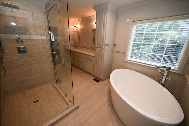 bathroom with separate shower and tub, crown molding, and vanity