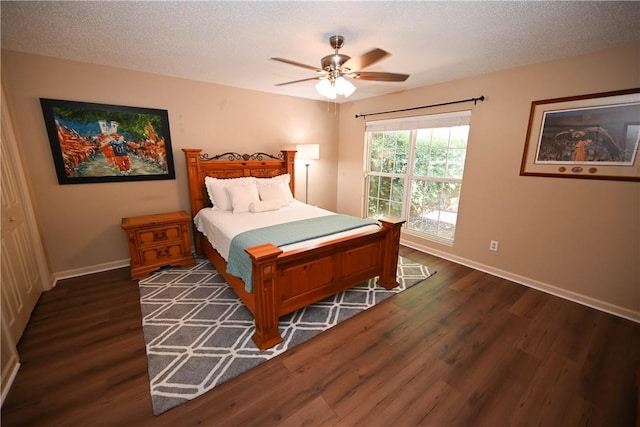 bedroom featuring a textured ceiling, ceiling fan, and dark wood-type flooring