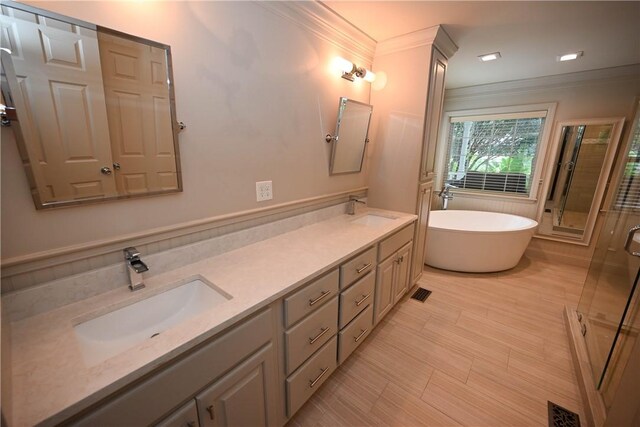1900 Wrights Mill Rd, Auburn, AL 36830 - bathroom featuring ornamental molding, a freestanding tub, a stall shower, and double vanity