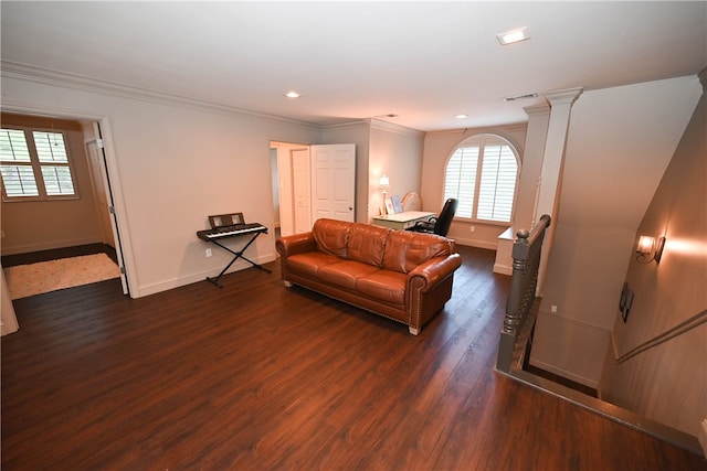 bedroom featuring ornate columns, crown molding, and dark hardwood / wood-style flooring