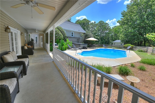 view of pool with ceiling fan, a patio, and a hot tub