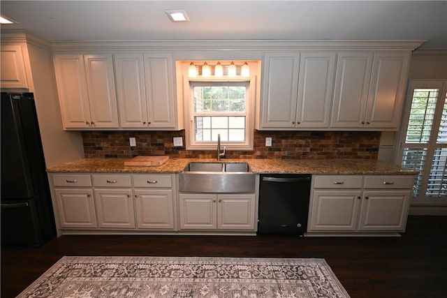 kitchen with white cabinetry, sink, and black appliances