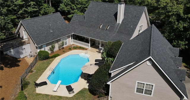 view of swimming pool with a diving board and a patio area