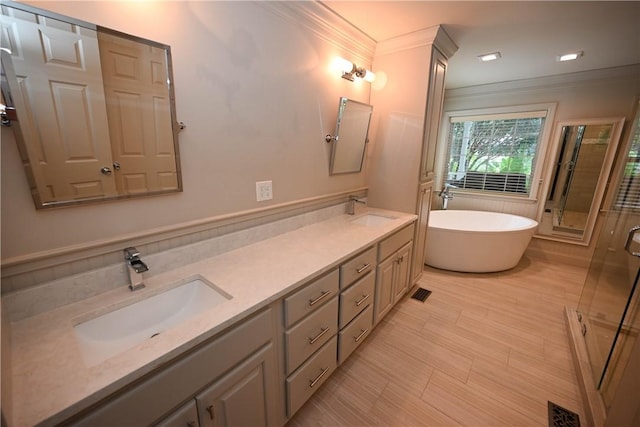 bathroom with vanity, separate shower and tub, and ornamental molding