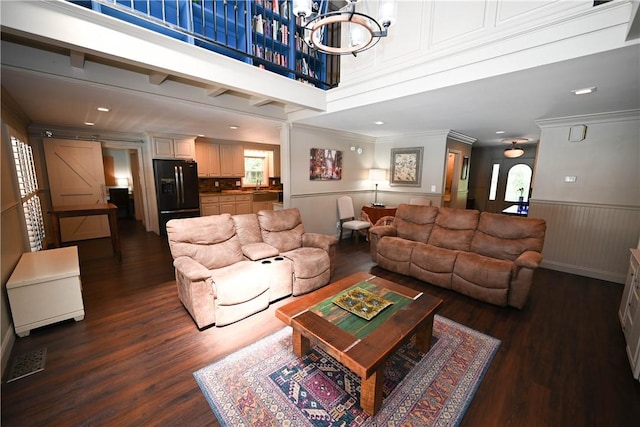 living room with ornamental molding, dark hardwood / wood-style floors, and a notable chandelier