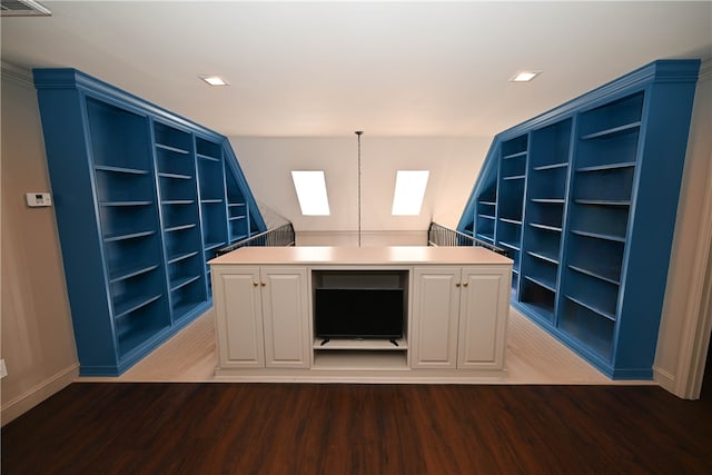 kitchen with built in shelves, a center island, white cabinetry, and hanging light fixtures