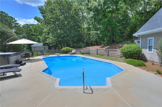 view of pool with an outbuilding and a patio area