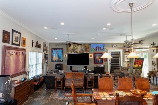 living room with a healthy amount of sunlight, ceiling fan, and crown molding