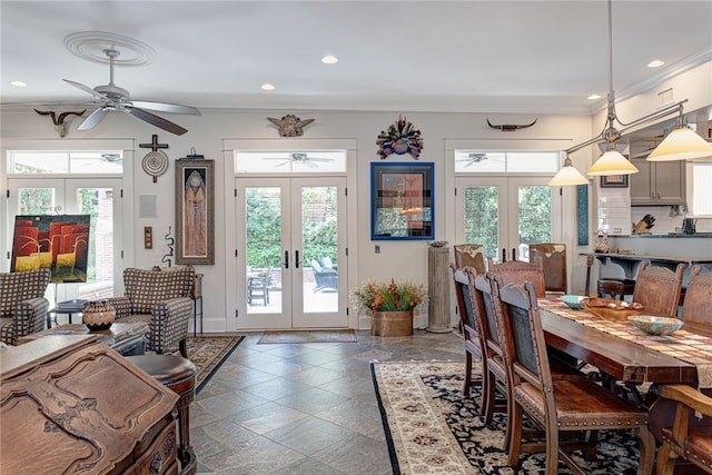 dining room with ceiling fan, crown molding, and french doors