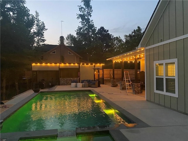 view of pool featuring a pool with connected hot tub, a patio, and fence