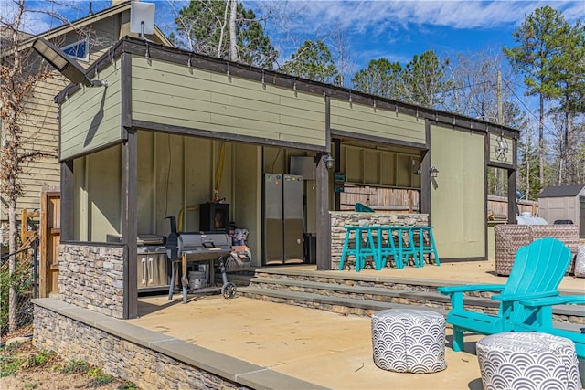 back of house with a patio, an outdoor structure, and fence