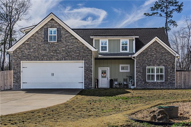 view of front facade featuring a garage, board and batten siding, concrete driveway, and fence