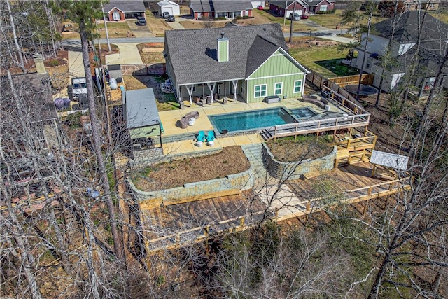 outdoor pool with a vegetable garden, a patio area, and a fenced backyard