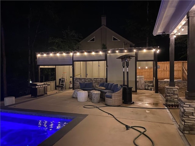 patio at twilight featuring outdoor lounge area and fence