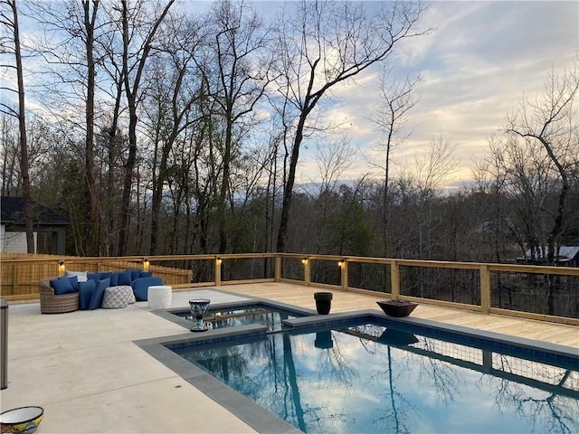 view of pool featuring an in ground hot tub