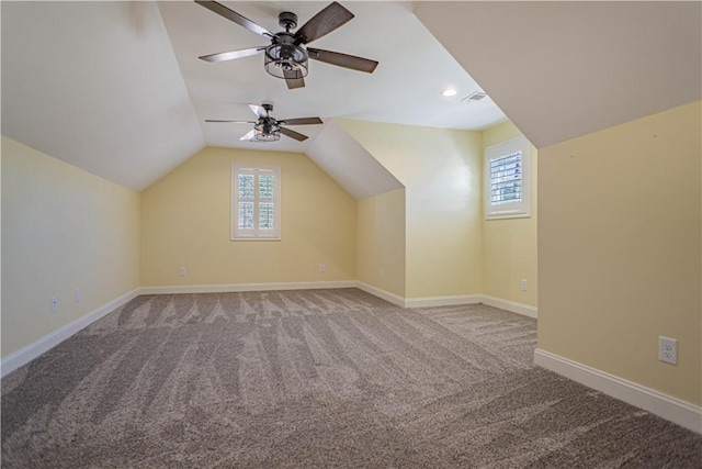 additional living space featuring a wealth of natural light, baseboards, carpet, and vaulted ceiling